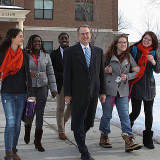 John 麦克维恩 and students walk in front of the ad building in the snow